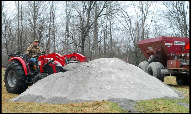 With 20 tons of lime delivered we used the loader on our McCormick X10.55 to fill the Spreader dropped off by the Coop.